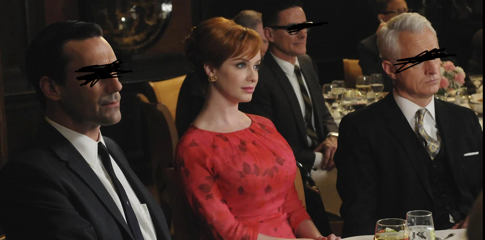 joan from mad men at an awards show flanked by two guys with their eyes gouged out 